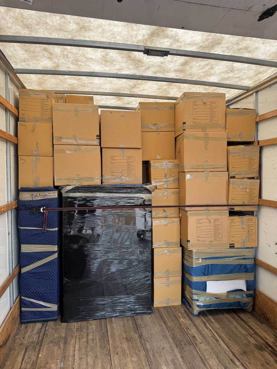 Packed moving truck interior showing secured furniture